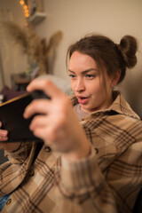 Close-up. Attractive young woman with a tablet in her hands. Focused facial expression. Video games, freelance, shopping, sales, leisure, hobbies. teaching.