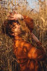 Portrait of a beautiful young woman posing outdoor with her eyes closed