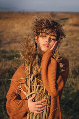 Portrait of a beautiful young woman with curly hair while enjoying the sun