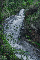 Mountain cascade waterfall inside of wild tropical woodland