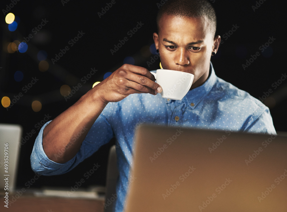 Poster just a little espresso to get him through the night. shot of a young man drinking an espresso while 