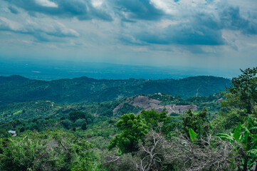 Fototapeta na wymiar Mountains view before raining. Exotic panorama on rain woodland