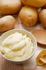 Fresh potato puree on potatoes background.