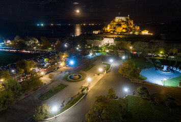 aerial drone view of the citylights of Corfu city at night. Kerkyra. Corfu island. Greece.