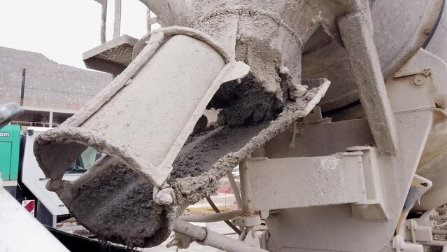 Mixer truck pours concrete to concrete pumping machine. Cement delivery to construction site. Construction machinery