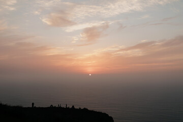 Incredible photo of sunset in the ocean. Bright orange sun in the blue and pink sky on the edge of Europe