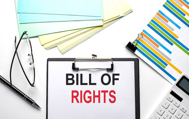 BILL OF RIGHTS text on paper sheet with chart,color paper and calculator