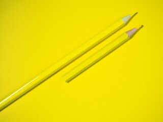 Yellow wooden pencil on yellow paper. Sharpened pencils. Drawing tool.  Accessories for creativity.