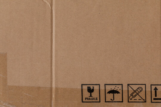 Worn Cardboard Texture With Clear Tape And Safety Symbols