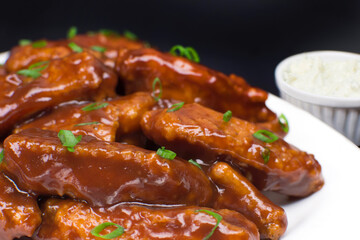 Fried chicken wings with barbecue sauce close
