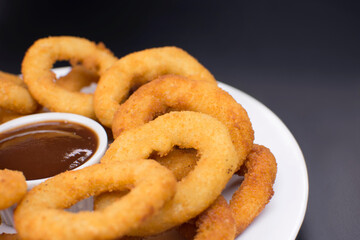 Onion rings with barbecue sauce close