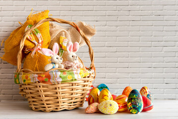 Easter decorated background, basket with eggs and cloth Easter bunny.