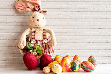 Easter decorated background, colored easter eggs and cloth bunny.