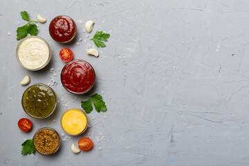 Many different sauces and herbs on table, flat lay top view. sauces with spices healthy concept