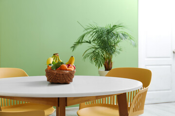 Wicker fruit basket on dining table in room