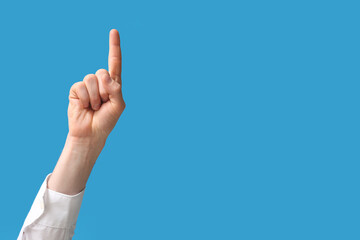 Businessman pointing at something on blue background