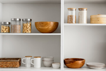 Shelf unit with clean dishware in kitchen