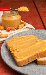 Fototapeta na wymiar Peanut butter sandwich on a wooden table. Vertical Banner.