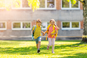 Boy and girl running to the school
