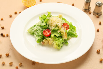 Plate with tasty vegan Caesar salad on beige background, closeup