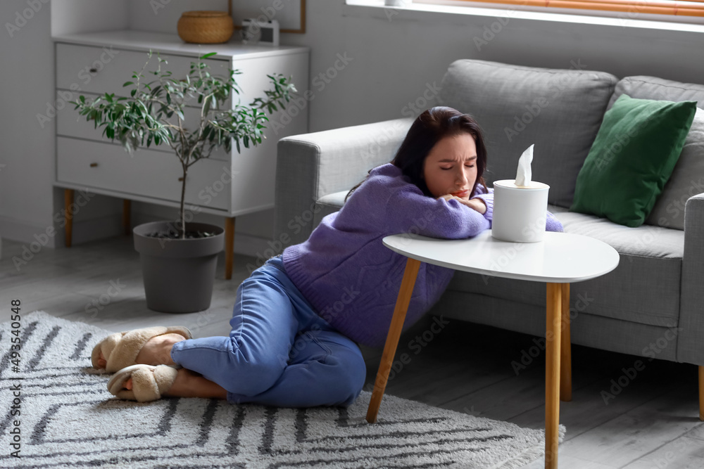 Wall mural worried young woman sitting at home