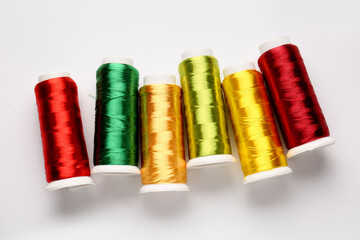 Different thread spools on white background