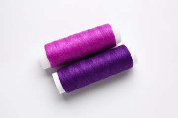 Different thread spools on white background