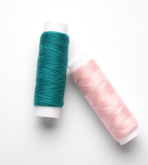 Different thread spools on white background