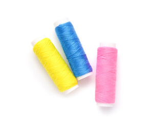 Different thread spools on white background