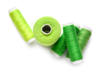 Different thread spools on white background