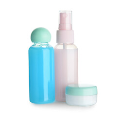 Travel bottles and jar with cosmetic products on white background