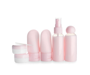 Set of travel bottles and jars with cosmetic products on white background