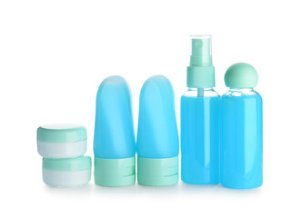 Set of travel bottles and jars with cosmetic products on white background