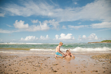 Fototapeta na wymiar Kids playing on the beach at Coffs Harbour, NSW Australia