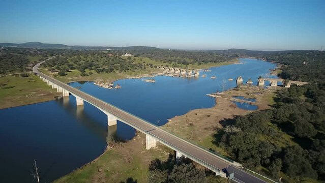 Aerial view of the border river Guadiana Between Elvas Portugal And Olivenza Spain and historic Ajuda Bridge. Destroyed abandoned Ajuda bridge drone aerial view