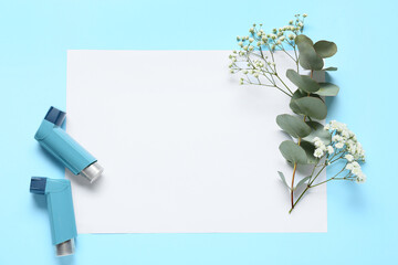 Composition with blank sheet of paper, inhalers, gypsophila flowers and eucalyptus branch on color...