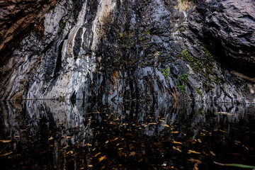 The Wall of Cattail Falls Reflects in The Dark Pool Below