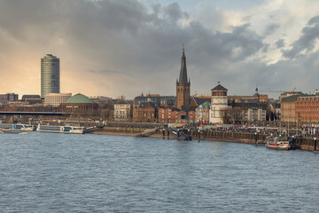 Fototapeta premium Duesseldorf embankment on warm spring evening on week-end, many people walking
