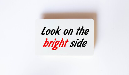 Look on the bright side advice or reminder - sticky note on a clipboard with a cup of tea