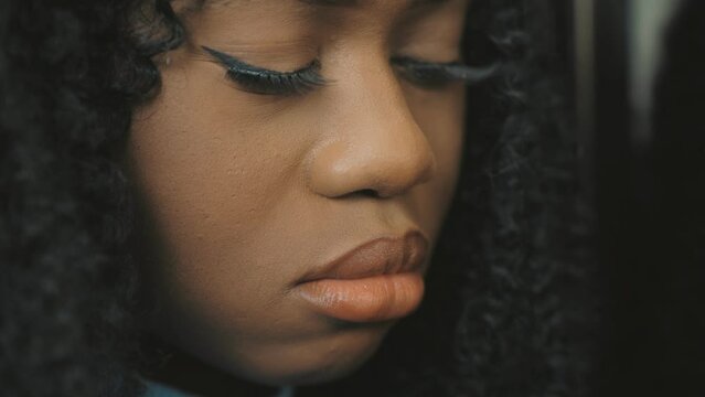 Close up side profile view of sad young african woman thinking of relationships