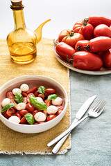 Caprese salad with tomatoes, mozzarella, basil and olive oil. Healthy mediterranean food.