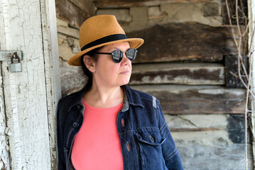 Portrait of an adult woman in a hat and sunglasses, . Fashionable and stylish woman.