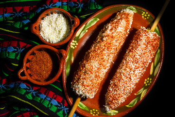 Typical Mexican dish, known as Elote with the ingredients of corn, mayonnaise, cheese and chili....