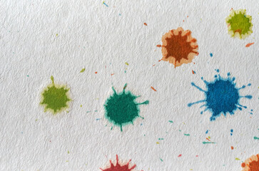 Colorful color stains on the rough textured paper
