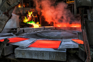 View of the copper casting to the molds in the smelting of the industrial plant. Smelting is a...