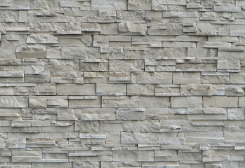 Wall of irregular natural stone blocks in shades of white