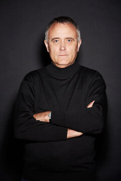Stern and confident. Studio portrait of a mature man isolated on black.