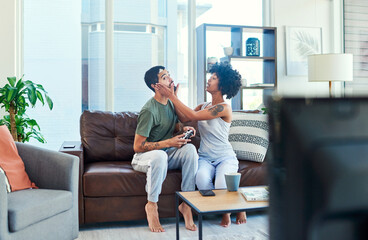 Youre going to make me lose. Shot of a woman trying to get her boyfriends attention while he plays video games.