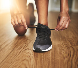 Get ready to run like your life depends on it. Cropped shot of a young woman tying her shoelaces.