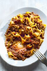 rustic italian pappardelle pasta in bolognese sauce